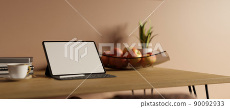 Minimal workspace with tablet mockup and wireless keyboard on wood table over pink pastel wall 90092933