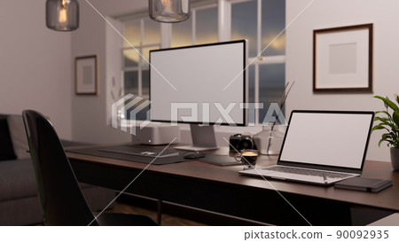 Modern stylish home office workstation with pc computer, notebook laptop on dark wood table. 90092935