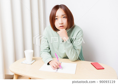 Young woman studying in the living room Young woman studying in the living room 90093119