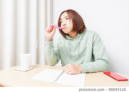 Young woman studying in the living room Young woman studying in the living room 90093126