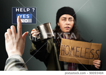 Female hand push a virtual button to the help. On the background defocused woman holds a cardboard sign with the text homeless and steel cup. The concept of helping the vagrants 90093484