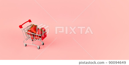 Fresh red strawberry in shopping card on pink background. Online shopping and Valentines Day minimalistic concept. Black Fridays sales banner. Healthy, organic, vegan food Fresh red strawberry in shopping card on pink background. Online shopping and Valentines Day minimalistic concept. Black Fridays sales banner. Healthy, organic, vegan food 90094649