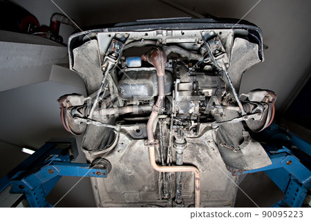 Cars lifted on an elevator in a garage 90095223