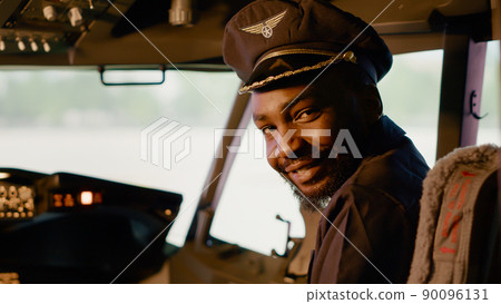 Portrait of male captain sitting in airplane cockpit to start engine, flying plane with dashboard power and control panel command. Windscreen and radar to takeoff, navigation compass. 90096131
