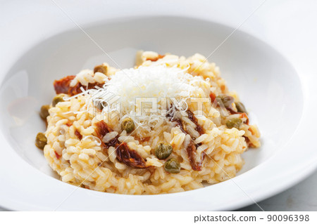 Italian risotto with dry tomatoes and capers Italian risotto with dry tomatoes and capers 90096398