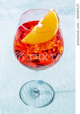 Aperol cocktail glass with an orange slice, Italian summer drink Aperol cocktail glass with an orange slice, Italian summer drink 90096425