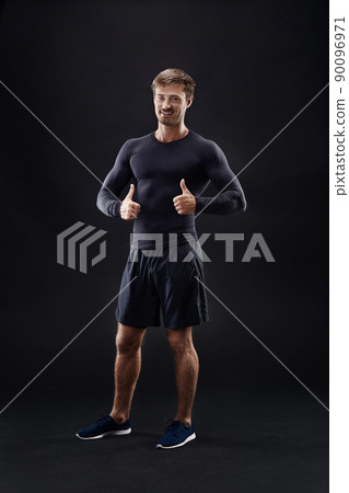 Male model in active sportswear against black background with copy space 90096971
