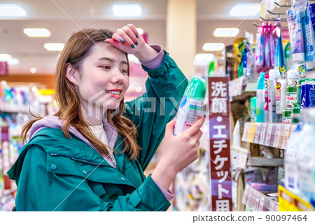 Young woman buying deodorant at the supermarket Young woman buying deodorant at the supermarket 90097464