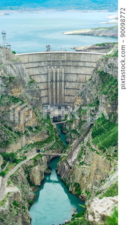 large arch dam of a hydroelectric power station on a river in a rocky canyon 90098772
