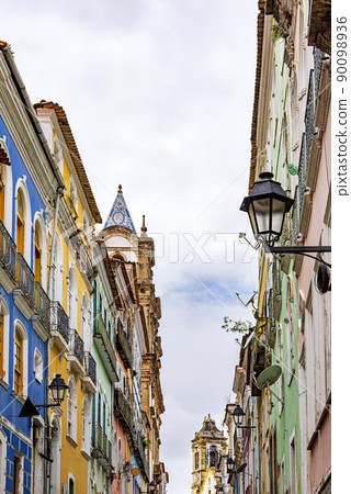 Facades of old houses and church towers in colonial style Facades of old houses and church towers in colonial style 90098936