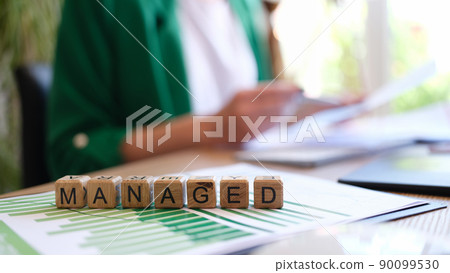 Text on cubes managed and business persons with graphs 90099530