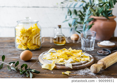 Homemade pasta Maltagliati with ingredients in rustic style Homemade pasta Maltagliati with ingredients in rustic style 90099931