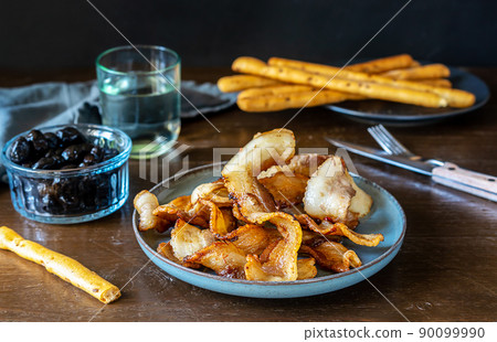 Fried crunchy slices of streaky bacon fried on plate Fried crunchy slices of streaky bacon fried on plate 90099990