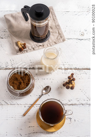 Healthy trendy coffee with mushrooms in cup, coffee pot, milk on white wooden background 90100028