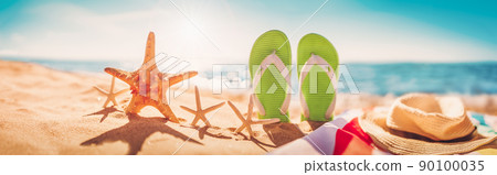 Beach accessories on the sand of the seacoast in summertime. Beach accessories on the sand of the seacoast in summertime. 90100035