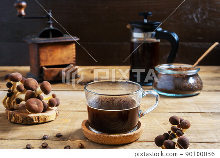 Coffee with mushrooms in mug, coffee grinder, ground coffee, mushrooms on wooden background Coffee with mushrooms in mug, coffee grinder, ground coffee, mushrooms on wooden background 90100036