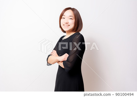 Woman in mourning dress standing in front of white background 90100494