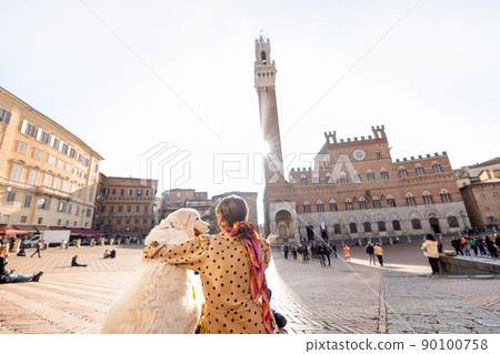 Woman traveling with dog at Siena town in Italy 90100758