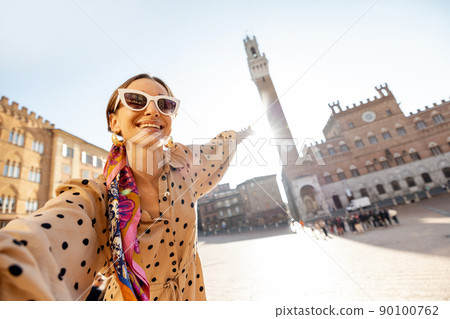 Woman on the main square of Siena town in Italy Woman on the main square of Siena town in Italy 90100762