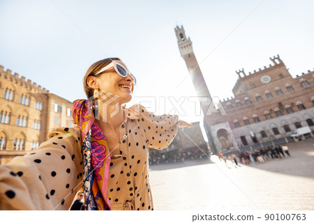 Woman on the main square of Siena town in Italy Woman on the main square of Siena town in Italy 90100763