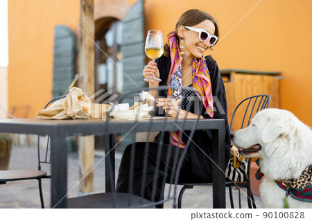 Woman tasting cheese and wine at local farm shop in Italy 90100828