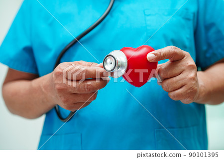 Asian woman doctor holding red heart for health in hospital. 90101395