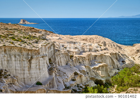 Famous white rocks of Sarakiniko beach, Aegean sea, Milos island , Greece. No people, empty cliffs, summer sunshine, clear sea waters Famous white rocks of Sarakiniko beach, Aegean sea, Milos island , Greece. No people, empty cliffs, summer sunshine, clear sea waters 90101402