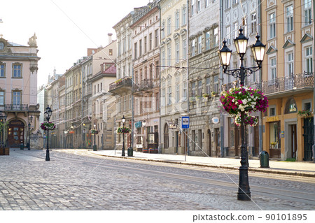 Traditional houses on a pedestrian street in the historic Old Town of Lviv, Ukraine. lanterns and many flowers. May 2021 90101895