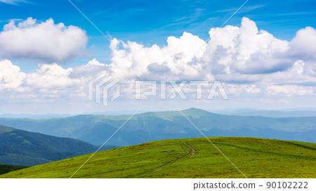 green landscape in dappled light. grassy hills of carpathian mountain scenery on a sunny day. sky with clouds above horizon green landscape in dappled light. grassy hills of carpathian mountain scenery on a sunny day. sky with clouds above horizon 90102222