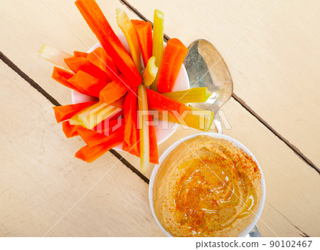 fresh hummus dip with raw carrot and celery fresh hummus dip with raw carrot and celery 90102467