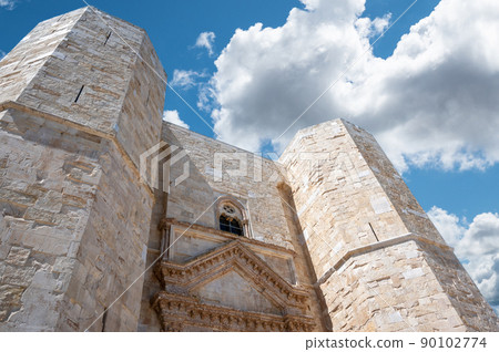 Andria, Puglia, Italy. August 2021. Detail of the imposing entrance of Castel del Monte. Beautiful sunny day with white clouds. 90102774