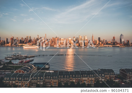 The skyscrapers of Manhattan skyline at twilight. Midtown West cityscape from across Hudson River, New York City, NY, USA 90104371