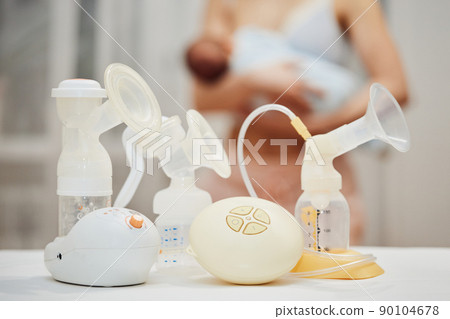 breast pump against the background of a mother holding child. breast pump against the background of a mother holding child. 90104678