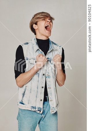 young man with mouth opened in shout on gray background young man with mouth opened in shout on gray background 90104825