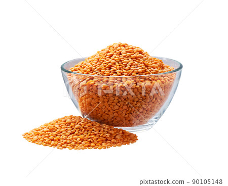 red lentils in a glass plate and scattered isolated on white background. red lentils in a glass plate and scattered isolated on white background. 90105148