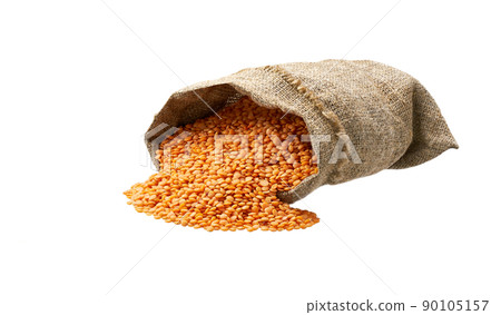 Organic red lentils in sack isolated on white background. Grains are scattered out of the bag. Organic red lentils in sack isolated on white background. Grains are scattered out of the bag. 90105157