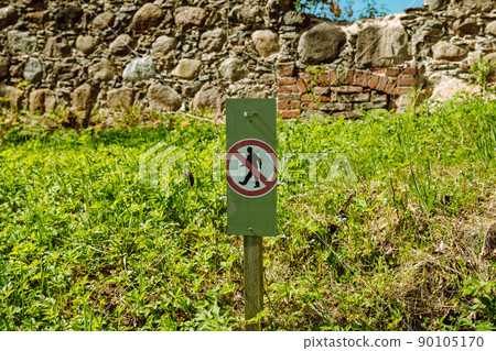 historically very old castle ruins in Latvia. outbuilding with a basement. sign for walking prohibited 90105170