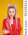 Emotional portrait of creative young woman in red suit on yellow background 90105812