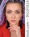Close-up face portrait of young woman with unusual fantastic colorful hair 90105814