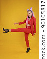 Emotional cocky model, bold person in studio making a step lifting leg high. 90105817