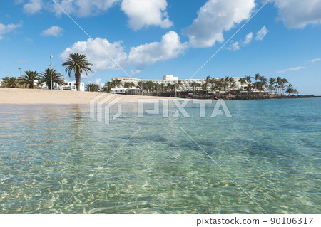 Sunny beach in, costa Teguise, Lanzarote, Canary Islands, Spain. Sunny beach in, costa Teguise, Lanzarote, Canary Islands, Spain. 90106317