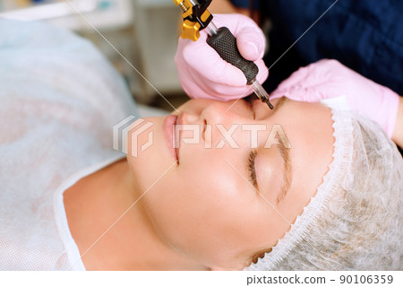 Image of a young beautiful woman dressed as a patient, lying on a couch in a cosmetology clinic. 90106359