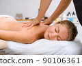 A beautiful young woman in the massage therapist's office lies on the couch. 90106361
