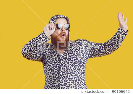 Portrait of funny comic chubby man who is strangely dressed and having fun on orange background. Portrait of funny comic chubby man who is strangely dressed and having fun on orange background. 90106643