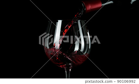 Close-up of pouring red wine into glass. 90106992
