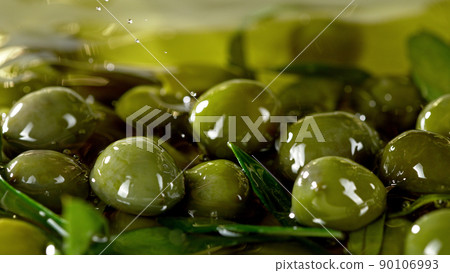 Close-up of green olives placed in oil. Close-up of green olives placed in oil. 90106993