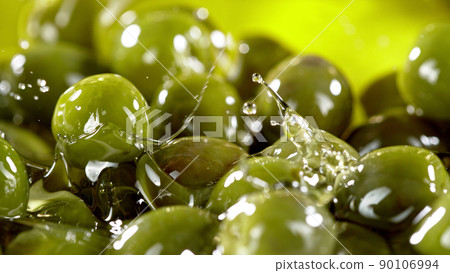 Close-up of green olives placed in oil. 90106994
