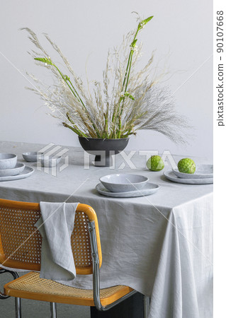 Elegant table setting with fresh asparagus boquet in craft vase , cherimoya fruits on linen tablecloth. Outdoor table setting for summer holiday concept. 90107668