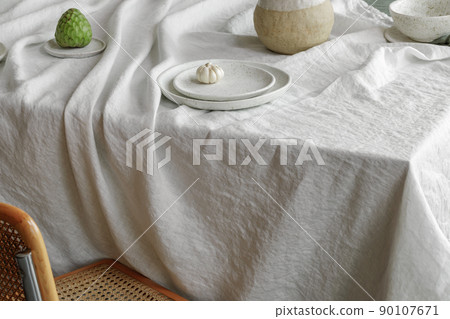 Elegant table setting with cherry brunch in craft vase , cherimoya fruits, garlic in craft ceramic plate on linen tablecloth. Outdoor table setting for summer holiday concept. 90107671