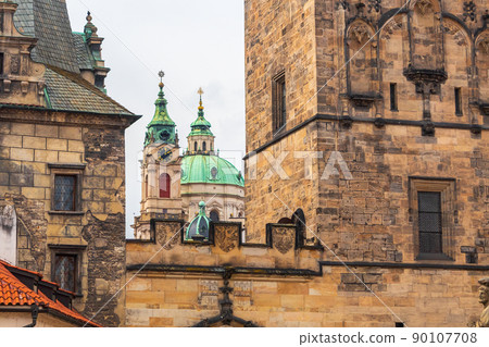 Church of Saint Nicholas in the Lesser Town, in foreground the walls of Mala Strana Bridge Tower, Prague, Czech republic 90107708